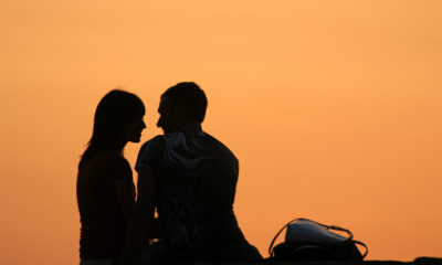 Couple giving romantic eye contact in the sunset