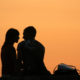 Couple giving romantic eye contact in the sunset