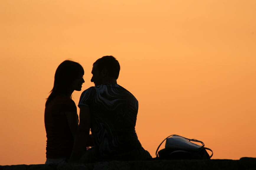 Couple giving romantic eye contact in the sunset