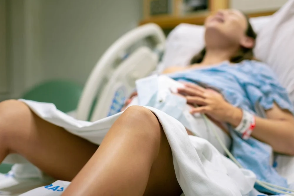 Woman screaming during child birth labour