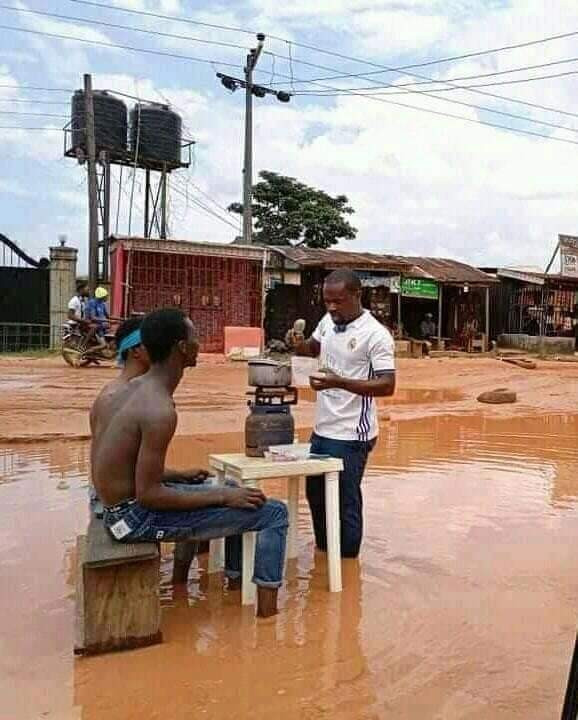 PHOTOS- Imo State Youths cook and demonstrate in muddy water to raise awareness about the terrible state of a road