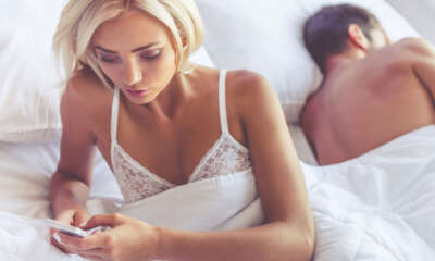 A cheating wife in bed with her husband