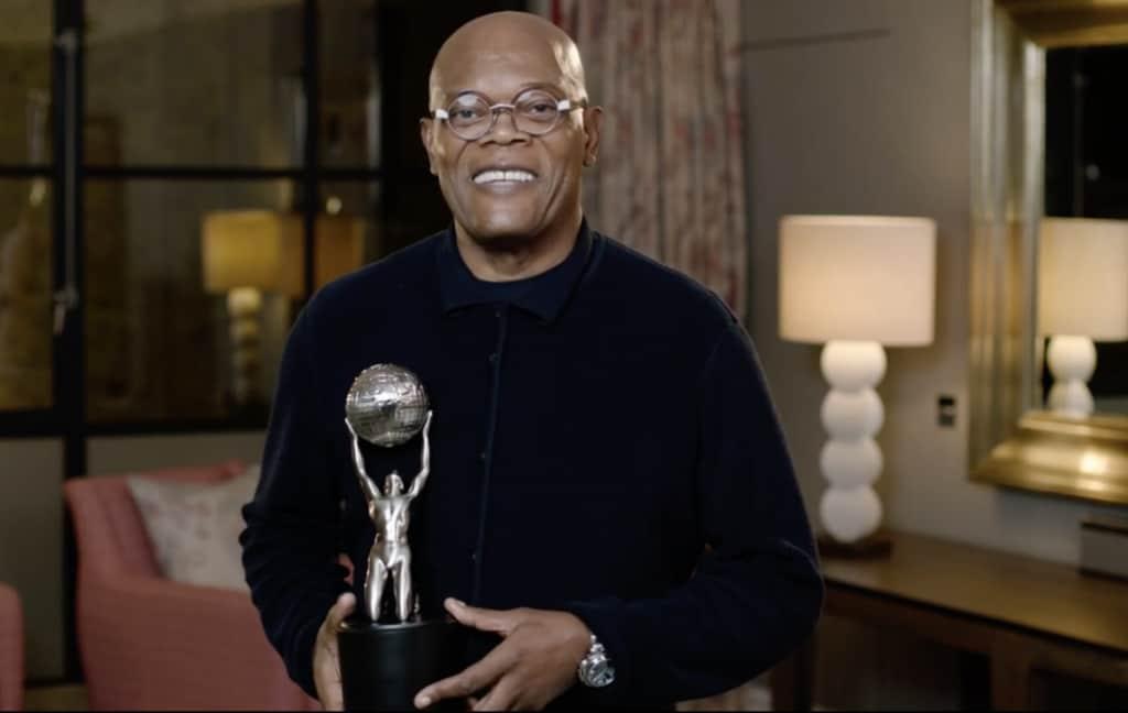 Samuel L. Jackson wearing glasses and smiling while holding an OSCAR award at the 2022 Governors Award
